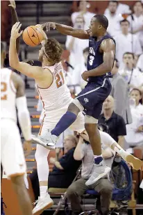  ?? AP Photo/Eric Gay ?? New Hampshire forward Jacoby Armstrong (3) blocks Texas forward Dylan Osetkowski (21) as he drives to the basket during the first half of an NCAA college basketball game Tuesday in Austin.