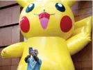  ??  ?? A man takes a selfie with a Pikachu during the first day of the 2019 Pokemon World Championsh­ips at the Washington Convention Center in Washington, DC. — AFP photos