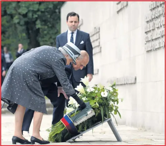  ?? Pictures: FABIAN BIMMER/ REUTERS, PA AND EPA ?? The Queen and Prince Philip yesterday lay a wreath at Bergen- Belsen and right, the Queen before the monument with its solemn message