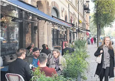  ?? NYT ?? Diners at a restaurant in Stockholm. The Swedish government has favoured social distancing over complete lockdowns.