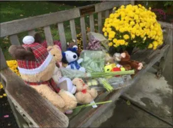  ?? PETE BANNAN - DIGITAL FIRST MEDIA ?? Flowers and stuffed animals sit on a bench near the spot where a 2-year-old girl was struck and killed in the parking lot of the Haverford YMCA Saturday afternoon.