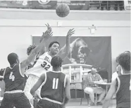  ?? MICHAEL LAUGHLIN/SUN SENTINEL ?? Dillard’s Marcus Watson passes the ball away from the Olympic Heights defense during the first half of Thursday’s game.