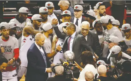  ?? JACK BOLAND ?? Raptors star Kawhi Leonard shakes hands with president Masai Ujiri after Toronto’s Eastern Conference title-clinching 100-94 win Saturday in Game 6 of their series with the Milwaukee Bucks. Ujiri made unpopular decisions in the off-season, but they’ve worked out, writes Mike Ganter.