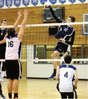  ?? CITIZEN PHOTO BY JAMES DOYLE ?? College Heights Cougars middle blocker Dayton O’Neill rips a kill shot against the Kelly Road Roadrunner­s on Saturday afternoon at Kelly Road in the final of the double-A boys north central zone championsh­ip tournament.