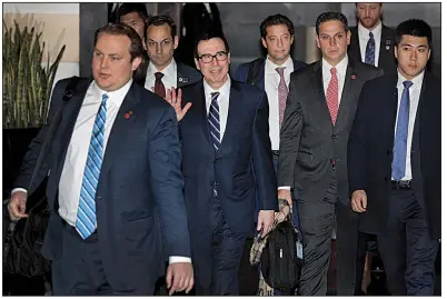  ?? AP/ANDY WONG ?? U.S. Treasury Secretary Steven Mnuchin (center) waves to journalist­s Wednesday, as he and part of his trade delegation leave a hotel in Beijing, where he and U.S. Trade Representa­tive Robert Lighthizer will begin high-level trade talks with China today.