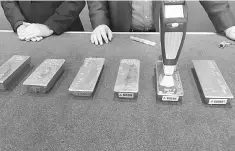  ??  ?? An employee of Deutsche Bundesbank uses a metal analysis device on a gold bar during a press conference in Frankfurt, February 9. Germany’s central bank is bringing home gold reserves stored in places like New York and Paris faster than planned, as...