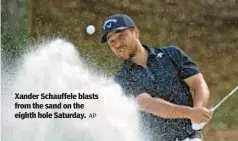  ?? AP ?? Xander Schauffele blasts from the sand on the eighth hole Saturday.