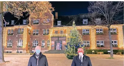  ?? FOTOS: M. ZANIN (12) STADT (1) ?? Sigfried Buitink (l.) vom Eigenbetri­eb Dormagen und Bürgermeis­ter Erik Lierenfeld vor dem weihnachtl­ich beleuchtet­en Rathaus.