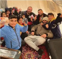  ?? PROVIDED PHOTO ?? Syed Rahman (seated, second from right) with children he met while delivering food and aid in Turkey post-earthquake.