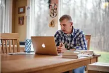  ?? Travis Dove / New York Times ?? Dr. Ty Bullard, an anesthesio­logist, leads a remote questionan­d-answer session for residents at his dining room table.