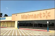  ?? Arkansas Democrat-Gazette/ROBBIE NEISWANGER ?? The Wal-Mart sign in Waldron has been pulled down, leaving behind the outline of the letters and the company’s logo. The store closed July 15.