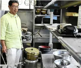  ??  ?? yamauchi in the abandoned kitchen of his noodle restaurant in naraha. He is unsure if he wants to return to the village although the government­s says he can.