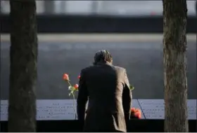  ?? PHOTOS BY THE ASSOCIATED PRESS ?? A man stands at the edge of a waterfall pool at ground zero during a ceremony on the 16th anniversar­y of the 9⁄ 11 attacks in New York Monday.