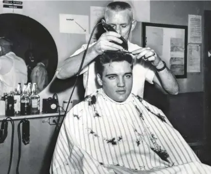 ??  ?? ELVIS’ FAMOUS POMPADOUR is buzzed away in the public hair-cutting ceremony that signaled the start of duty.
