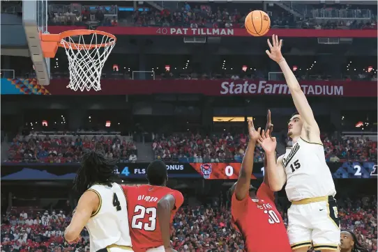  ?? JAMIE SQUIRE/GETTY ?? Purdue center Zach Edey puts up a shot over North Carolina State forward DJ Burns Jr. during an NCAA men’s semifinal Saturday at State Farm Stadium in Glendale, Arizona. The game was in progress at press time. Defending champion UConn faced No. 4 seed Alabama in the second semifinal.