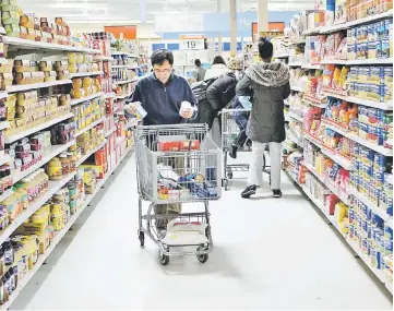  ??  ?? Customers shop for food inside a Wal-Mart store in Secaucus, New Jersey, on Feb 17, 2009. — WP-Bloomberg photo