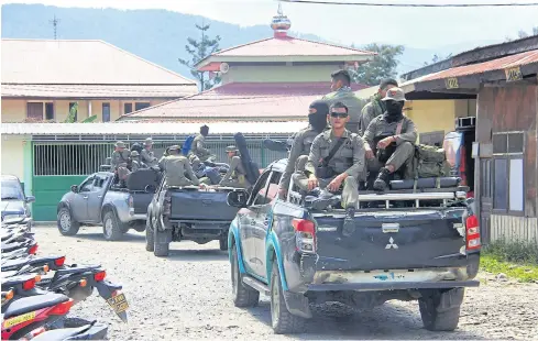  ?? AFP ?? Indonesian Mobile Brigade Police head to Nduga, where as many as 31 people are believed to have been shot dead, from Wamena on Tuesday.