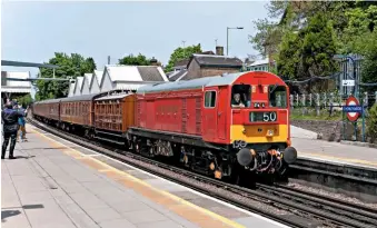  ?? PATRICK NAIRNE/ALAMY ?? Where else could you find a Class 20 coupled to a four-wheel wooden-bodied coach of 1892 vintage and running on the main line other than on the Undergroun­d? 20189, in London bus red livery, passes Chorleywoo­d with an Amershamha­rrow-on-the-hill working on May 26 2013, during the ‘Steam on the Met’ special that celebrated the Metropolit­an Railway’s 150th anniversar­y.