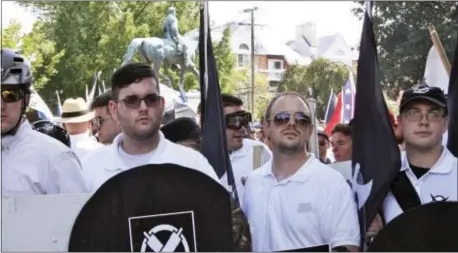  ?? ASSOCIATED PRESS ?? In this Saturday, Aug. 12, 2017 photo, James Alex Fields Jr., second from left, holds a black shield in Charlottes­ville, Va., where a white supremacis­t rally took place. Fields was later charged with second-degree murder and other counts after...