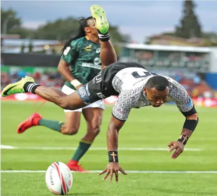  ?? Photo: World Rugby. ?? Fiji Airways Fijian 7s winger Alasio Naduva dives over to score a try against South Africa during the HSBC World Sevens Series.