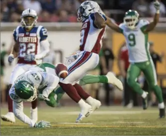  ?? CANADIAN PRESS FILE PHOTO ?? Saskatchew­an Roughrider­s wide receiver Bakari Grant drops the ball on a play ruled a touchdown while being tackled by Montreal Alouettes defensive back Travis Hawkin on Thursday night.