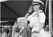  ?? AUDREY MCAVOY/AP ?? Everett Hyland, seated, who survived the attack, salutes along with his granddaugh­ter, Navy Cmdr. Anna-Marie Fine, during Friday’s remembranc­e at Pearl Harbor.