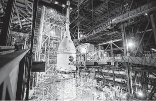  ?? Frank Michaux / NASA ?? The Orion spacecraft for NASA’S Artemis I mission is lifted above the Space Launch System rocket, completing assembly for the flight test last month at Kennedy Space Center in Florida.