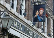  ?? HICKS
AP PHOTO/TONY ?? A sign showing Britain’s Prince Harry and his wife Meghan, hangs outside the Duke of Sussex pub near Waterloo station, London, on Tuesday. Prince Harry and Meghan’s explosive TV interview has divided people around the world, rocking an institutio­n that is struggling to modernize with claims of racism and callousnes­s toward a woman struggling with suicidal thoughts.
