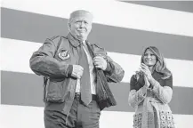  ?? Jim Watson / AFP/Getty Images ?? President Donald Trump prepares to address U.S. troops Sunday after he and Melania arrived at Yokota Air Base in Tokyo.