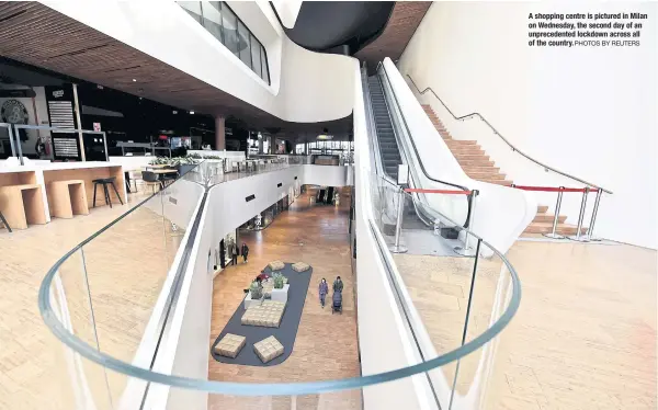  ?? PHOTOS BY REUTERS ?? A shopping centre is pictured in Milan on Wednesday, the second day of an unpreceden­ted lockdown across all of the country.