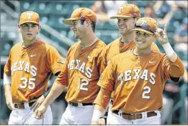  ?? RALPH BARRERA / AMERICAN-STATESMAN ?? Mark Payton flashes the Hook ’Em sign as Madison Carter (fromleft), Jacob Felts and Weston Hall look on during senior day last month.