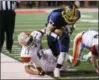  ?? DAVID TURBEN — THE NEWS-HERALD ?? Kirtland’s Ryan Lipps keeps his balance in bounds during a 44-0 Division VI state semifinal win over Nelsonvill­e-York.