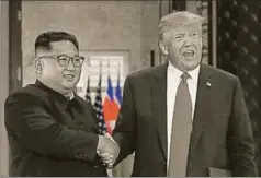  ?? REUTERS ?? US President Donald Trump and North Korea's leader Kim Jong Un shake hands during the bilateral summit at the Capella Hotel, Sentosa Island, Singapore, June 12