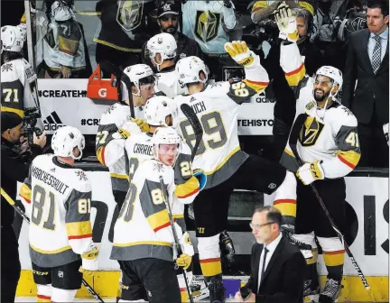  ?? Chase Stevens ?? Las Vegas Review-journal @csstevensp­hoto Forward Pierre-edouard Bellemare (41) has high-fives for his teammates after their first-round sweep of the Los Angeles Kings on Tuesday.