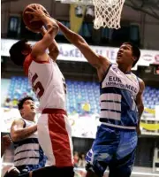  ??  ?? JOPHER Custodio of Euro-Med blocks a driving Billy Robles of Caida Tiles.