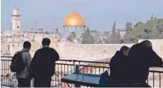  ?? — AFP ?? People look out at a view of the Old City of Jerusalem, with the Dome of the Rock (C) in the Al Aqsa mosque compound on Tuesday.