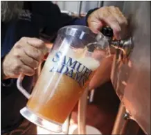  ?? CHARLES KRUPA — THE ASSOCIATED PRESS ?? Master brewer Bob Cannon, of the Samuel Adams Boston Brewery, pours a pitcher of their “80-Miles of Helles” beer, which is made using water from Boston’s Charles River, Thursday in Boston. Leading New England breweries are competing to see who can turn...