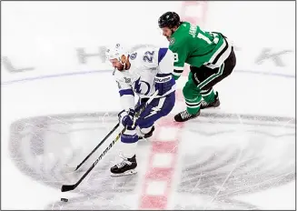  ??  ?? Dallas Stars center Mattias Janmark (13) chases Tampa Bay Lightning defenseman Kevin Shattenkir­k (22) during
the first period of Game 4 of the NHL hockey Stanley Cup Final on Sept 25, in Edmonton, Alberta. (AP)