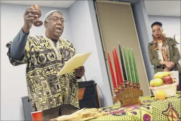  ?? Cindy Schultz / Times Union archive ?? Brother Aaron Carter, left, takes part in the annual African American Cultural Center of the Capital Region Kwanzaa Celebratio­n in 2016 in Albany.