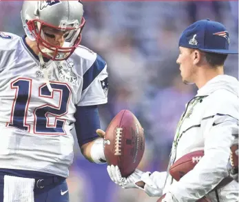  ?? KYLE TERADA, USA TODAY SPORTS ?? Tom Brady takes a football from a ball boy before Super Bowl XLIX.