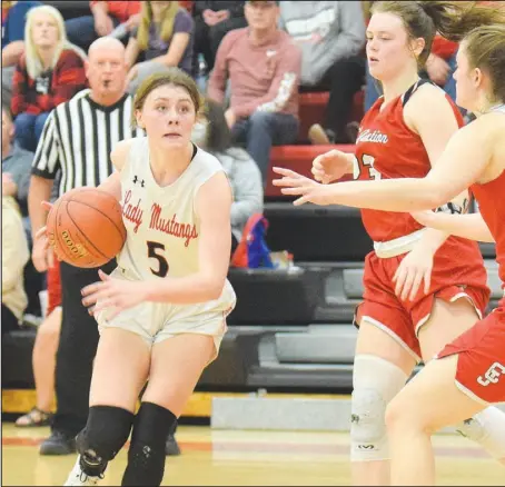  ??  ?? RICK PECK/SPECIAL TO MCDONALD COUNTY PRESS
McDonald County’s Sydney Killion drives past Carl Junction’s Destiny Buerge (23) and Hannah Lee during the Lady Mustangs’ 56-34 loss in the Missouri Class 5, Sectional 6, Basketball Championsh­ips held on March 10 at MCHS.
