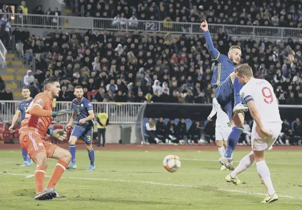  ?? PICTURE: MICHAEL REGAN/GETTY IMAGES ?? 0 Harry Kane side-foots home the second goal to become the first England player to score in every match in a qualifying campaign.