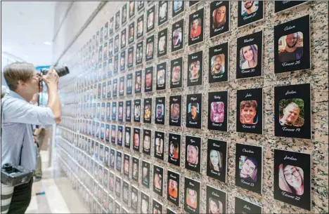  ?? (AP) ?? A photojourn­alist takes pictures of the exhibits on ‘The Faces of Fentanyl’ at DEA headquarte­rs before a press event at DEA headquarte­rs, Arlington, Va., in this file photo from Sept. 27, 2022. Heading into key elections, there have been assertions that the drug might be handed out like Halloween candy, something the US Drug Enforcemen­t Agency’s head has said isn’t true. And some candidates for elected office frame the crisis as mostly a border-control issue, though experts say the key to reining in the crisis is reducing demand for the drugs.