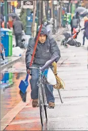  ??  ?? Bike path of least resistance: An overloaded Manhattan cyclist riding the wrong way.