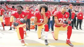  ??  ?? Colin Kaepernick, centre, first started the kneeling protests in 2016.