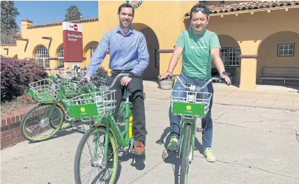  ??  ?? Co-founders Toby Sun, right, and Caen Contee of California-based bike sharing startup LimeBike show off their bikes at a recentlyla­unched pilot programme in Burlingame, California on March 8, 2017.