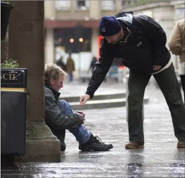  ??  ?? Begging in Glasgow city centre