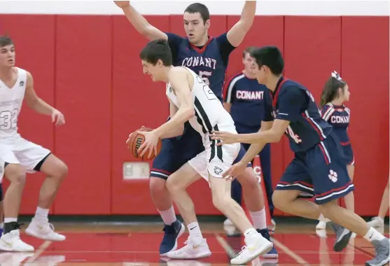  ?? | ALLEN CUNNINGHAM/ FOR THE SUN- TIMES ?? Libertyvil­le’sDrewPeter­son ( with ball) scored 20 points in a rowin the second half and made a buzzer- beating three- pointer Friday to beat Conant.