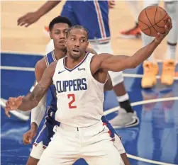  ?? BRAD PENNER/USA TODAY SPORTS ?? Clippers small forward Kawhi Leonard (2) controls the ball against Knicks shooting guard RJ Barrett during the second quarter Sunday in New York.