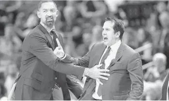  ?? LYNNE SLADKY/AP ?? Heat assistant coach Juwan Howard, left, holds back coach Erik Spoelstra as he yells at an official during Friday’s loss.